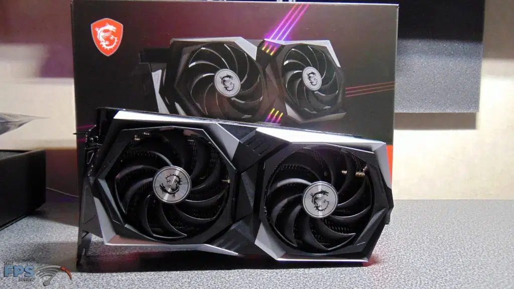 MSI Radeon RX 6700 XT GAMING X standing up on table in front of box