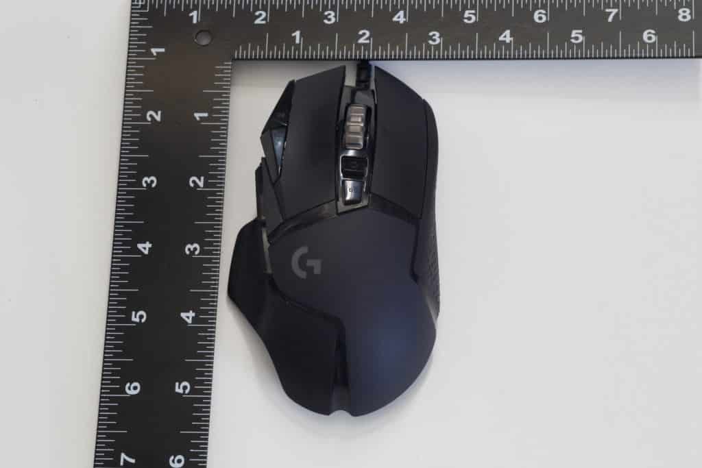 Logitech G502 HERO High Performance Gaming Mouse next to ruler showing size