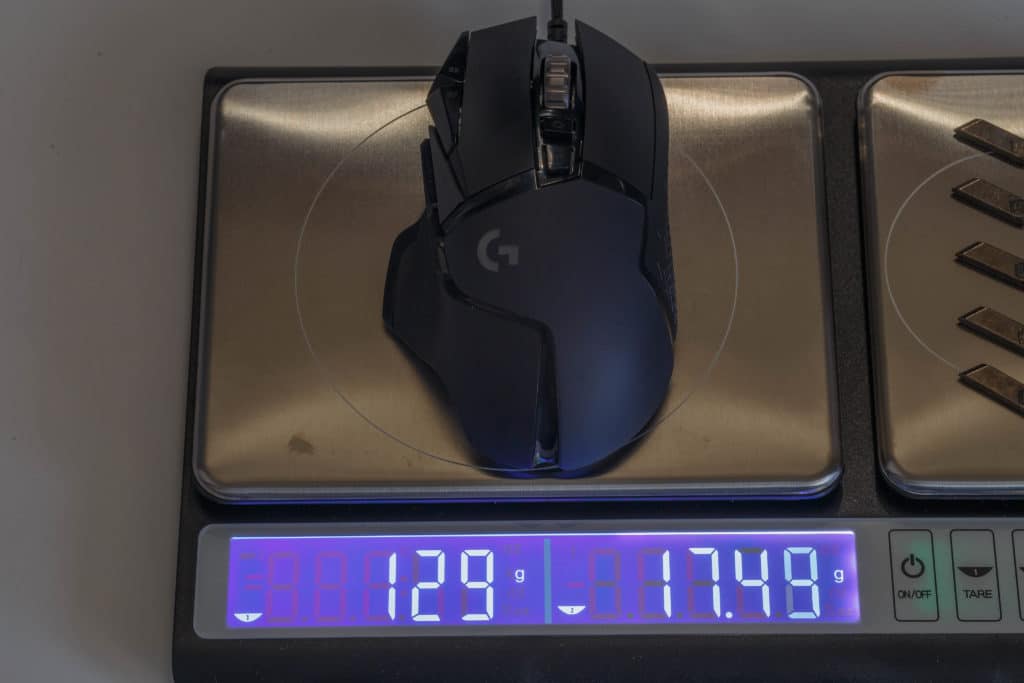Logitech G502 HERO High Performance Gaming Mouse on scale showing weight
