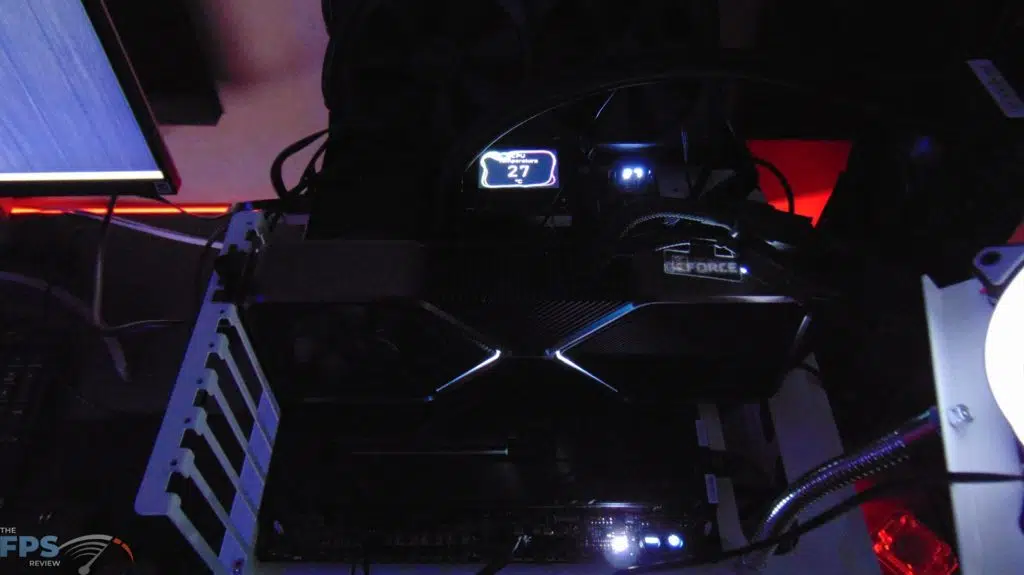 MSI MEG Z690 UNIFY Motherboard Top View with MSI MEG Coreliquid S360 AIO Cooler installed with LCD Screen Turned On in the dark