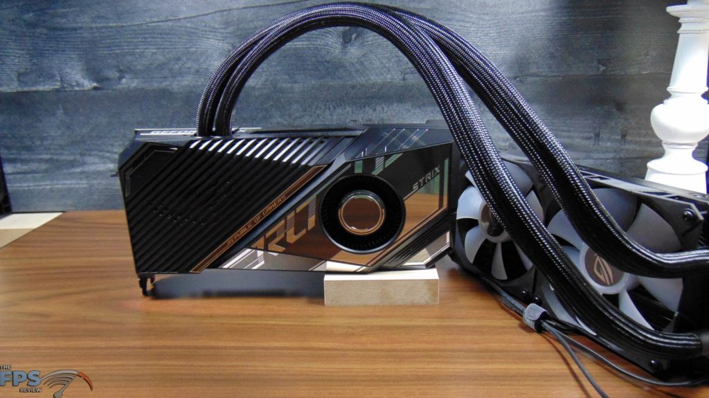 ASUS ROG STRIX LC RTX 3080 Ti O12G GAMING video card on desk sitting up right front view with radiator to the right side