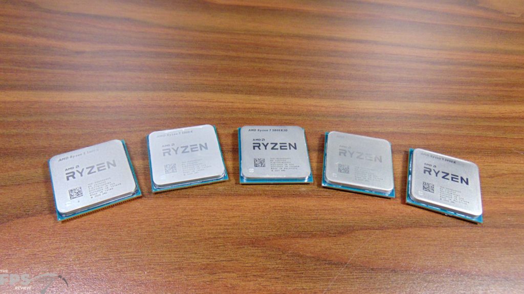 AMD Ryzen 9 5950X CPU and AMD Ryzen 9 5900X CPU and AMD Ryzen 7 5800X3D CPU and AMD Ryzen 7 5800X CPU and AMD Ryzen 5600X CPU sitting side by side on table