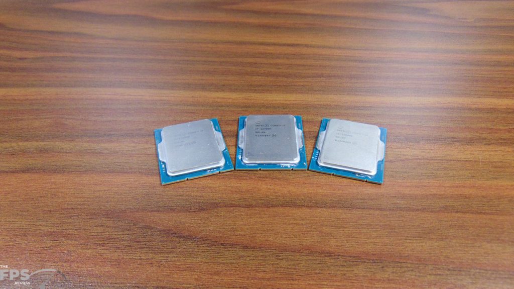 Intel Core i9-12900K CPU and Intel Core i7-12700K CPU and Intel Core i5-12600K CPU sitting on table side by side
